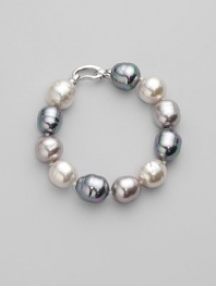 A stunning bracelet of baroque pearls in a palette of whisper soft pastels. 14mm white, grey and nuage man-made organic pearls Length, about 8 Rhodium-plated sterling silver spring clip clasp Made in Spain