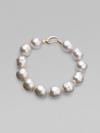 An elegant strand of white organic pearls, with a graceful clasp. 14mm white baroque man-made pearls Length, about 8 18k goldplated sterling silver spring clip clasp Made in Spain