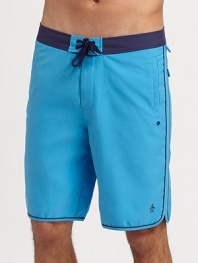 A modern, knee-length swim favorite in quick-dry nylon with tonal trim and ventilating grommets. Drawstring waist Side slash, back patch pockets Mesh lining Inseam, about 9½ Polyester Machine wash Imported 