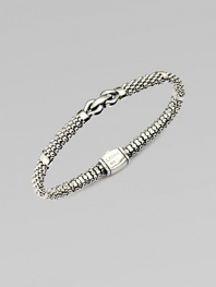 An elegant piece with in textured sterling silver accented with a center link detail . Sterling silverDiameter, about 2¼Box clasp closureImported 