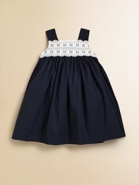 A sweet and simple frock offers a little fuss with lace detail along the neckline.Squareneck with scalloped lace detailWide strapsBack buttonsEmpire waist with back bow tie65% polyester/35% cottonMachine wash coldImported Please note: Number of buttons may vary depending on size ordered. 