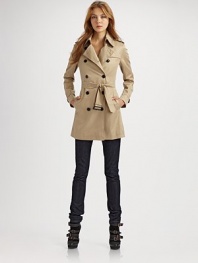 Chic, double-breasted silhouette has classic trench styling and a check-lined collar.Foldover collar has check underside Epaulets Gun flap Double-breasted buttons Self-belt Vented back Fully lined About 31 from shoulder to hem Polyester; dry clean Imported
