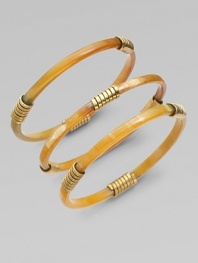 A set of three slender bangles of richly mottled natural horn, wrapped here and there in shiny flat brass wire.Natural cow hornBrassDiameter, about 3Imported