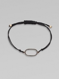 A knotted cord with a black diamond encrusted, 18K rose gold, oval link. Black diamonds, .25 tcw18K rose goldPolyester cordLink size, about ¾Length, about 13½ adjustableDrawstring closureImported 