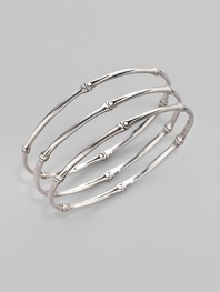 From the Bamboo Collection. Slim and elegant in fine sterling silver, this set of three bangles displays the graceful pattern of bamboo. This design was expressly created to support an afforestation project on Nusa Penida, an arid island off the coast of Bali. For every purchase, John Hardy will donate a portion of the retail price to the cost of planting bamboo. This bangle set helped plant 6 bamboo seedlings. Sterling silver Diameter, about 2½ Set of 3 Made in Bali