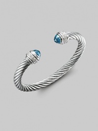From the Silver Ice Collection. A bold twisted cable of sterling silver, capped with faceted blue topaz and banded with pavé diamonds. Diamonds, 0.48 tcw Blue topaz Sterling silver Cable, 7mm Diameter, about 2¼ Made in USA