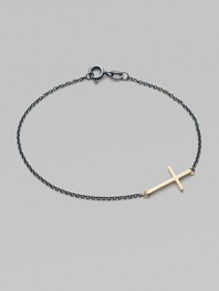 A gleaming 14k gold cross on an oxidized sterling silver chain.14k yellow gold Oxidized sterling silver Length, about 7 Pendant length, about ¾ Spring ring clasp Made in USA