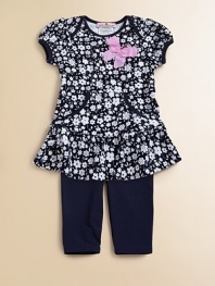 A floral ruffled tunic with pockets complements a matching pair of soft leggings.Envelope necklineShort cap sleevesPullover styleKangaroo pocketsSkirted hemElastic waistbandLogo embroideryTunic: 65% cotton/35% rayonLeggings: 94% cotton/6% spandexMachine washImportedAdditional InformationKid's Apparel Size Guide 