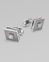 High-polish rhodium-plated metal with a fixed square back, hatched texture and rotating tiers. T backingAbout ½ diam.Plated metalMade in the United Kingdom