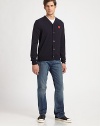 Cozy wool v-neck with a button-down front and vibrant heart emblem. V-neckButton frontLong sleevesWoolDry cleanImported