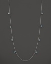 Inspired by Zen philosophy, this intricately detailed sterling silver necklace from Paul Morelli softly jingles with eight meditation bells and cabochons of blue topaz.