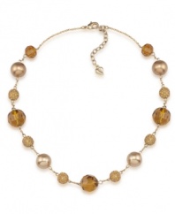 Golden rules. Gold-hued glass pearls are complemented by alluring amber-colored fireball accents on Carolee's chic illusion necklace. Made in gold tone mixed metal, it will add polish to your workday wardrobe. Approximate length: 16 inches + 2-inch extender.
