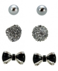 Style in the making. Create a new look every day in GUESS's mix and matchable three pair earring set. Earring set features a pair of shiny glass pearls, a crystal-encrusted cone stud, and black epoxy bows. Set in silver and hematite tone mixed metal. Approximate diameters: 6 mm (pearl); 3/8 inch (cone stud); 3/8 x 5/8 inch (bow stud).
