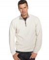 A crisp white quarter zip-up sweater is an eye-catching novelty amid the dark colors of fall. Made by Izod, the sweater is 100% cotton--a desirable material for the months leading up to winter.