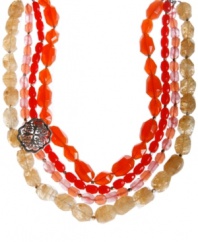 Long, luxe layers add an exotic vibe to any look. Lucky Brand's multi-strand torsade necklace features rich glass and plastic beads in red and neutral hues. Accented by an openwork brooch at the corner. Crafted in mixed metal. Approximate length: 30 inches + 2-inch extender.