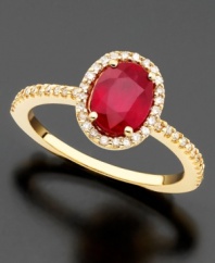 An oval-cut ruby (1-3/8 ct. t.w.) revels in a regal setting of 14k gold and round-cut diamonds (1/4 ct. t.w.) on this Effy Collection ring.