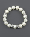 Exude timeless elegance in effortless, slip-on style. Givenchy bracelet features polished glass pearls accented by silver tone mixed metal beads and sparkling crystals. Bracelet stretches to fit wrist. Approximate diameter: 2-1/2 inches.
