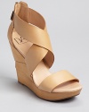 Wide straps and a boldly towering wedge are vacation-perfect. Pair DIANE von FURSTENBERG's sandals with tropical hues.