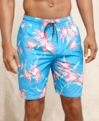 Get inspired for summer with these tropical print swim trunks from Tommy Hilfiger.
