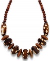 A rustic revelation. The brown wood and brown and white-spotted resin beads on Style&co.'s statement necklace come in a variety of sizes for an intriguing appearance. Set in gold tone mixed metal. Approximate length: 18 inches + 2-inch extender.