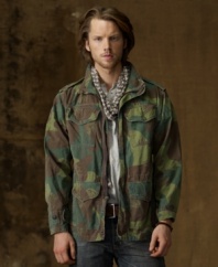 The ever-rugged camo print is artfully reinterpreted on this durable cotton canvas jacket, putting a hip downtown spin on authentic military styling.