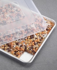 Creating just the right amount of crispy treats, brownies and cookies has never been easier on this half sheet with a natural aluminum core for even baking and great success. Handy lid pops on to keep contents safe and secure on the way to school, brunch or keep them fresh for another day. Lifetime warranty.