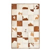 The bold brown and white cowhide patchwork motif on this Ralph Lauren rug warms your living space with a sleek interpretation of Western style.