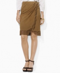 Western inspiration comes to life in Lauren by Ralph Lauren's luxuriously soft suede skirt, crafted with a straight-wrap silhouette with fun fringe trim.