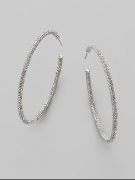 EXCLUSIVELY AT SAKS. Large, luxurious hoops, accented with the shimmer of pavé crystals. Crystals Rhodium plated Diameter, about 2¼ Stainless steel post back Imported