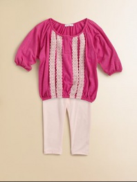 Pretty lace trim, a gathered silhouette and matching leggings make this sweet set a must-have for baby. Tunic ScoopneckThree-quarter sleevesElastic hem Leggings Elastic waistbandTop: rayonLeggings: 95% cotton/5% spandexMachine washImported