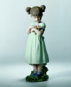 This sweet porcelain figurine depicts a little girl gathering posies for Mom. Porcelain. Makes a wonderful gift. 8.5 x 2.75.