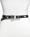 Salvatore Ferragamo's skinny black leather belt is a must-wear this season. Top your favorite dresses or tops with a signature status look. With silver hardware and a bow buckle closure.