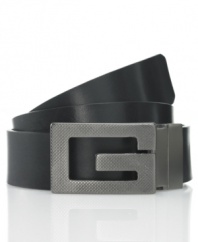 Add some instant edge to your jeans when you finish off your look with the oversized textured metal G of this sleek logo belt from GUESS.