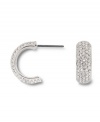 Covered in glittering pave crystals, Swarovski's huggie hoop earrings are a chic, classic look that's versatile enough to take you from the office to a night on the town! Set in silver tone mixed metal. Approximate diameter: 1/2 inch.