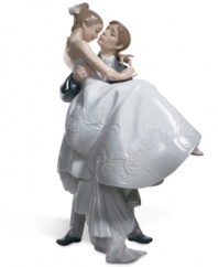 The handsome groom carries his blushing bride over the threshhold in this romantic scene from Lladro. Porcelain. Measures 10.75 x 6.75.