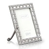 Add a chic and glamorous touch to your home décor with this beautifully detailed frame. A unique latticework of high quality metal combines genuine handset Swarovski round and emerald cut crystals.