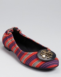 Reimagined in a colorful stripe-printed canvas, the Reva flat gets a patterned makeover. From Tory Burch.