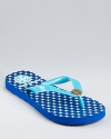 A bright, patterned footbed lends graphic punch to a summery pair of Tory Burch flip flops.