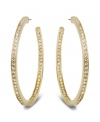 Star-studded style. This elegant pair of gold tone hoop earrings sparkles in clear Swarovski crystal pavé, reflecting the light beautifully and adding a touch of sophistication to any outfit. Approximate diameter: 1-7/8 inches.
