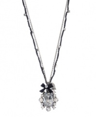 Elegance and flirtation combine. Betsey Johnson pendant highlights a Czech crystal surrounded by glass stones and accented by a ribbon charm. Crafted in silver tone mixed metal. Approximate length: 16 inches + 3-inch extender. Approximate drop: 1-1/2 inches.