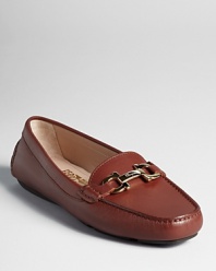 Luxe leather and a golden logo accent lend elegance to a streamlined, classic loafer from Salvatore Ferragamo.